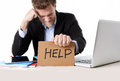 Picture_of_man_holding_help_sign_at_computer_2